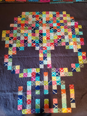Bright colored pixel skull quilt